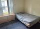 Simple bedroom with a double bed, side table, and large window for natural light at 123 S Roma Way, Kissimmee, FL 34746