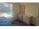 Bedroom showcases pool view, dresser, and side tables in a naturally lit space at 123 S Roma Way, Kissimmee, FL 34746