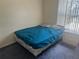 Bedroom featuring a comfortable bed, side table, and plenty of natural light at 123 S Roma Way, Kissimmee, FL 34746