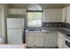 Bright kitchen features a stainless steel sink and ample counter space at 123 S Roma Way, Kissimmee, FL 34746