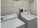 A basic laundry room with white appliances at 123 S Roma Way, Kissimmee, FL 34746