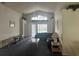 Cozy living room featuring vaulted ceilings, a ceiling fan, and sliding glass doors to the pool at 123 S Roma Way, Kissimmee, FL 34746
