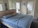 Relaxing main bedroom features a large bed, bedside table, and mirrored closet doors at 123 S Roma Way, Kissimmee, FL 34746
