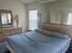 Serene main bedroom with a large bed, dresser, and mirrored closet, offering ample storage at 123 S Roma Way, Kissimmee, FL 34746