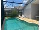 An in-ground pool with a screened enclosure and lounge chairs at 123 S Roma Way, Kissimmee, FL 34746