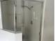 Bathroom showcasing a glass-enclosed shower with a showerhead and tiled walls at 123 S Roma Way, Kissimmee, FL 34746