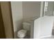 Bathroom featuring a toilet and a partial view of the glass enclosed shower at 123 S Roma Way, Kissimmee, FL 34746