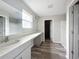 Bright bathroom featuring double sinks, modern vanity, vinyl flooring, and separate shower stall at 1404 Axel Cir, Winter Haven, FL 33880
