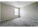 Carpeted empty bedroom with a window offering natural light at 1404 Axel Cir, Winter Haven, FL 33880