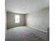 Neutral bedroom with carpeting and a window offering natural light at 1404 Axel Cir, Winter Haven, FL 33880