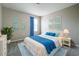 Cozy bedroom featuring a large bed with blue accents and matching wall art at 1404 Axel Cir, Winter Haven, FL 33880
