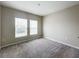 Carpeted bedroom featuring double windows that fill the space with bright, natural light at 1404 Axel Cir, Winter Haven, FL 33880