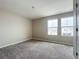 Neutral bedroom with carpeting and double windows providing natural light at 1404 Axel Cir, Winter Haven, FL 33880