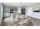 Modern kitchen features gray cabinets, stainless steel appliances, a kitchen island, and a dining area at 1404 Axel Cir, Winter Haven, FL 33880