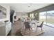Open-concept living room features modern decor, wood floors, stairs, and natural light from sliding glass door at 1404 Axel Cir, Winter Haven, FL 33880