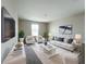 Modern living room with stylish white furniture, a large TV, and decorative plants at 1404 Axel Cir, Winter Haven, FL 33880