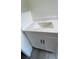 Bathroom features a modern vanity with marble countertops, white cabinets, and chrome hardware at 1427 Orchid Ln, Kissimmee, FL 34744