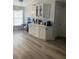 Bright kitchen with lots of counter space, white cabinets, stainless steel appliances, and wood-style floors at 1427 Orchid Ln, Kissimmee, FL 34744