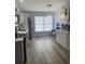 Spacious kitchen showcasing stainless steel appliances, white cabinets, granite counters, and ample counter space at 1427 Orchid Ln, Kissimmee, FL 34744