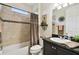 Cozy bathroom showcases stylish tile, a framed mirror, and a shower-tub combination for relaxation and convenience at 1703 Encinitas Way, Kissimmee, FL 34759