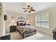 Cozy bedroom with neutral colors, a ceiling fan, and a bright window at 1703 Encinitas Way, Kissimmee, FL 34759