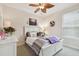 Bright bedroom features white furniture, neutral walls, and a decorative wreath above the bed at 1703 Encinitas Way, Kissimmee, FL 34759