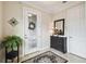 Welcoming foyer with decorative glass door, mirror, console table, and tiled floor at 1703 Encinitas Way, Kissimmee, FL 34759