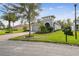 Charming single-story home with well-manicured lawn, mature trees, and paver driveway at 1703 Encinitas Way, Kissimmee, FL 34759