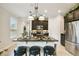 Modern kitchen island with pendant lighting and stainless steel appliances at 1703 Encinitas Way, Kissimmee, FL 34759