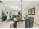 Bright kitchen with granite island overlooking the dining area at 1703 Encinitas Way, Kissimmee, FL 34759