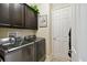Well-organized laundry room featuring modern washer and dryer, storage cabinets, and neutral walls at 1703 Encinitas Way, Kissimmee, FL 34759