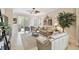 Comfortable living room with neutral tones, ceiling fan, and sliding glass doors to the patio at 1703 Encinitas Way, Kissimmee, FL 34759