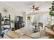 Inviting living room with comfortable seating, ceiling fan, and access to the outdoor patio at 1703 Encinitas Way, Kissimmee, FL 34759