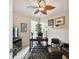 Inviting home office features a desk, leather seating, decor, and natural lighting for a productive workspace at 1703 Encinitas Way, Kissimmee, FL 34759