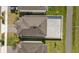 An aerial view highlights the backyard's paved patio and the home's roof at 1765 Petiole Pl, Kissimmee, FL 34744