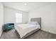 Bedroom with carpet, window, accent chair, and modern furnishings at 1765 Petiole Pl, Kissimmee, FL 34744
