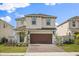 Charming two-story home with a brick driveway and a two-car garage at 1765 Petiole Pl, Kissimmee, FL 34744