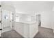 A second floor hallway with neutral carpet and white walls; several entrances to other rooms are pictured at 1765 Petiole Pl, Kissimmee, FL 34744