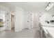 Hallway with a bedroom, closet, and bathroom all leading off of gray tile flooring at 1765 Petiole Pl, Kissimmee, FL 34744