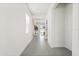 Hallway with tile flooring leading to the living area, featuring a window for natural light at 1765 Petiole Pl, Kissimmee, FL 34744
