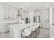 Modern kitchen featuring sleek white cabinetry, stainless steel appliances, and a large island at 1765 Petiole Pl, Kissimmee, FL 34744