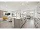 Bright open-concept kitchen with large island, modern appliances, and seamless flow to dining and living areas at 1765 Petiole Pl, Kissimmee, FL 34744