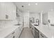 Bright kitchen with sleek white cabinetry, stainless steel appliances, and ample counter space at 1765 Petiole Pl, Kissimmee, FL 34744