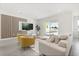 Bright living room features modern wood paneling, recessed lighting, and neutral decor at 1765 Petiole Pl, Kissimmee, FL 34744