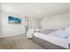 Bright main bedroom with neutral tones, featuring a large bed, seating area, and flat screen television at 1765 Petiole Pl, Kissimmee, FL 34744