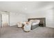 A large main bedroom with cozy seating area and a neutral palette at 1765 Petiole Pl, Kissimmee, FL 34744