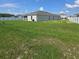 Expansive backyard with lush green grass and a pristine white fence offering privacy at 200 Citrine Loop, Kissimmee, FL 34758