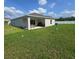 Exterior view of home showcasing the expansive, lush backyard with a covered patio, a grilling area and privacy fence at 200 Citrine Loop, Kissimmee, FL 34758