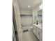 Bright bathroom featuring a shower-tub combination and a single sink vanity at 200 Citrine Loop, Kissimmee, FL 34758