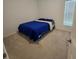 Cozy bedroom with carpet floors, a window, and a comfortable bed with blue bedding at 200 Citrine Loop, Kissimmee, FL 34758
